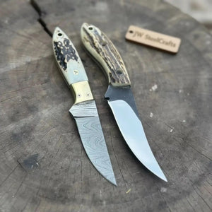 Handmade damascus steel knife with bone handle on dark surface