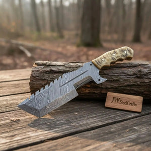 Handmade damascus steel knife with horn handle on dark surface