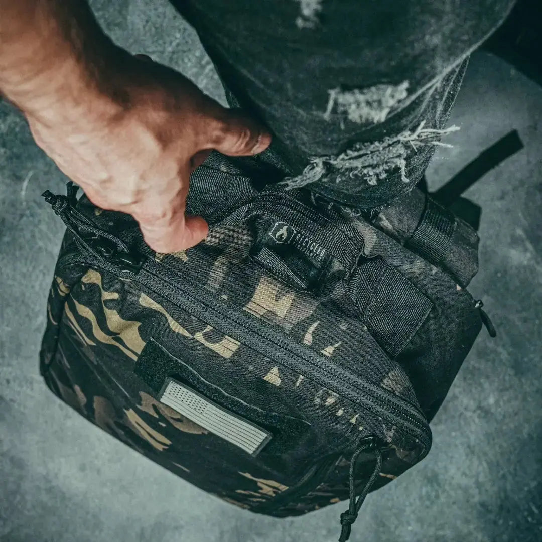 Black and camouflage tactical backpack with American flag patch.