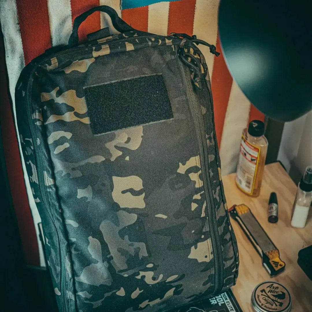 Camouflage pattern backpack with a black patch on the front.