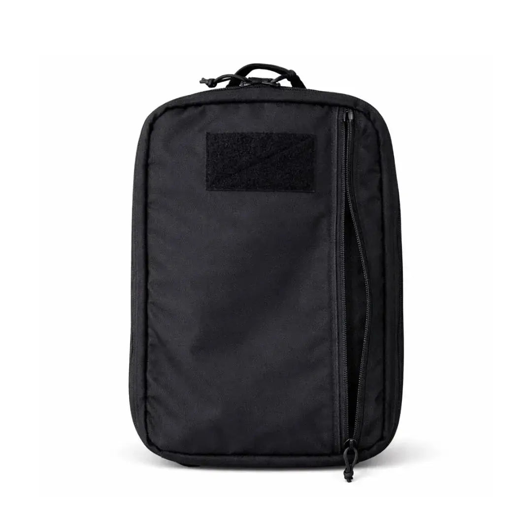 Black backpack with a square velcro patch on the front and a partial zipper.