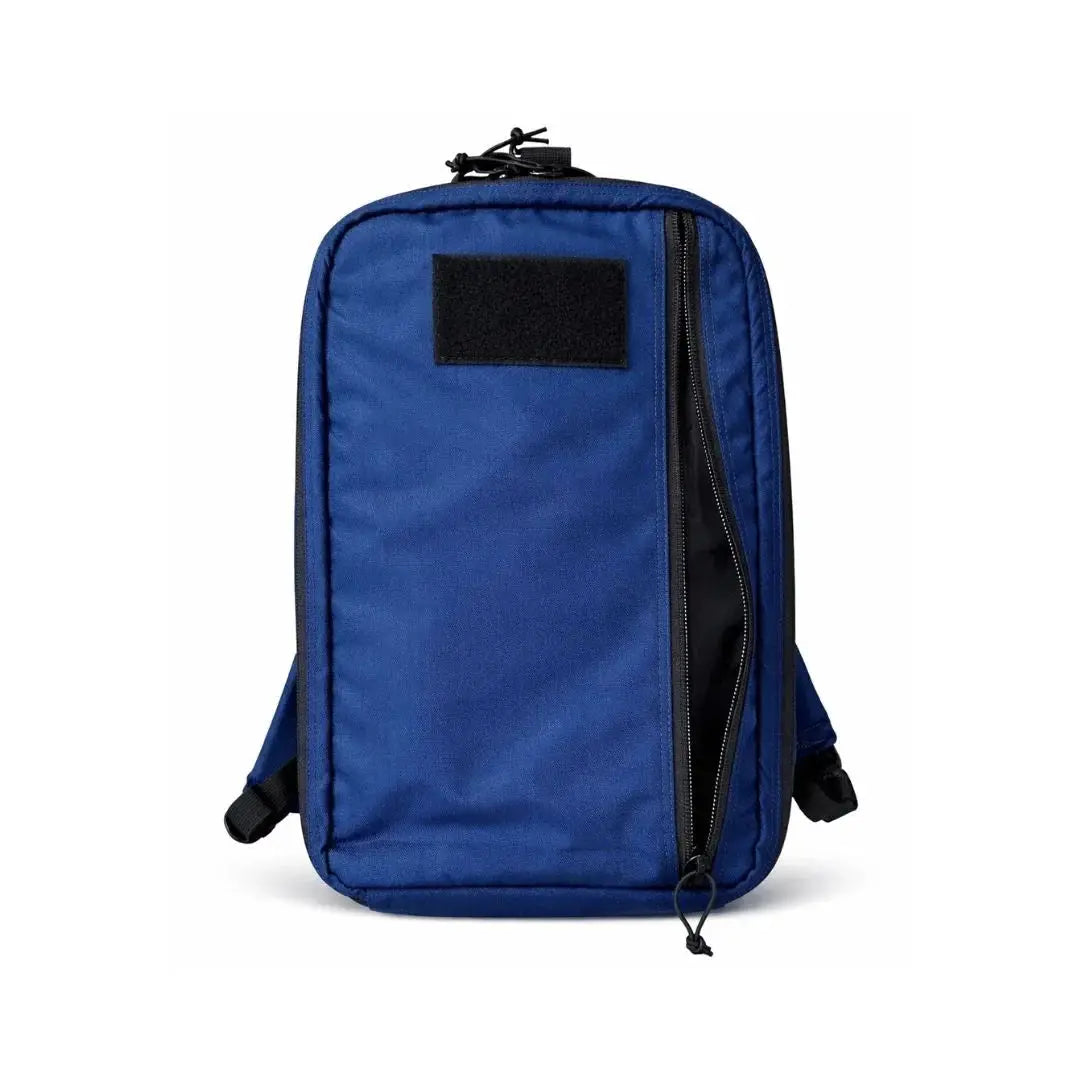Blue backpack with a black patch and a partially open zipper pocket.