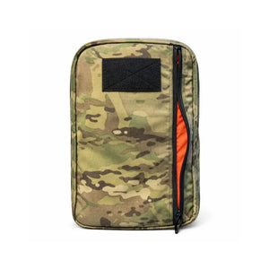 Camouflage backpack with orange interior and black patch