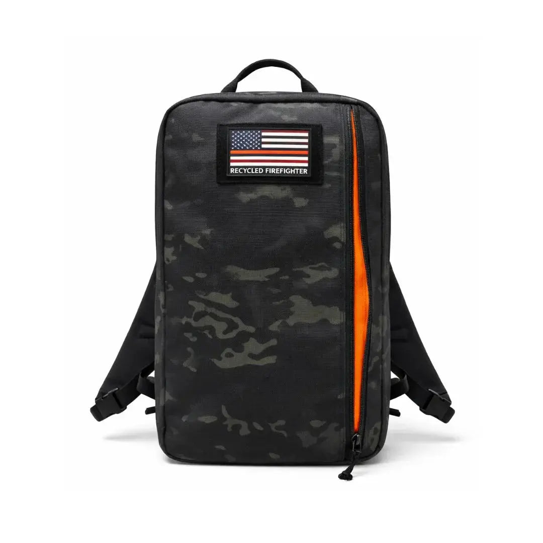 Black and gray camouflage backpack with a bright orange zipper and a "Recycled Firefighter" patch.