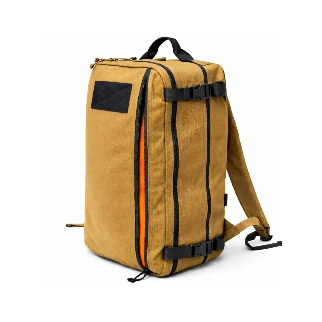 Tan canvas backpack with orange zipper detail and black straps
