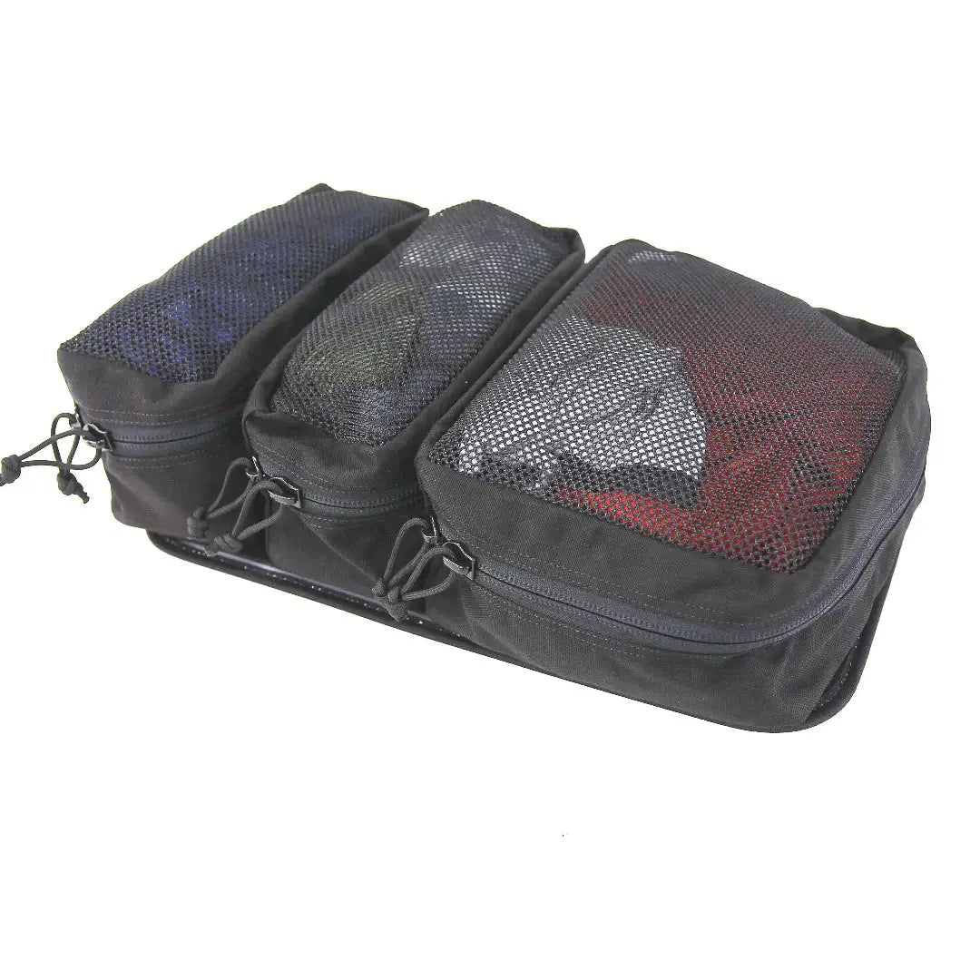 Black organizer with three mesh-top compartments containing items.