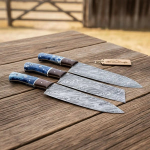 Handmade damascus steel knife with wood handle on dark surface