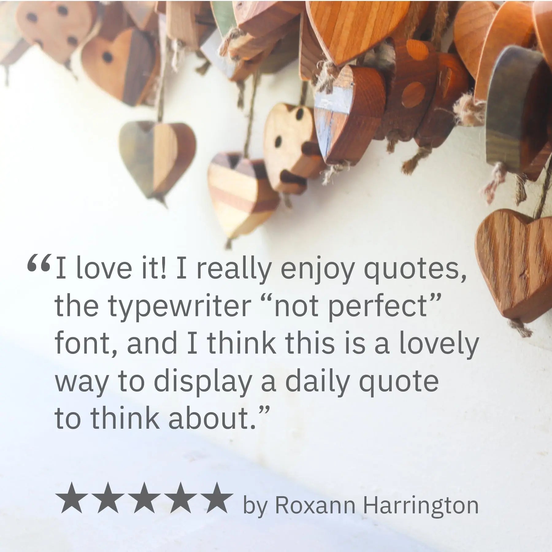 Close-up of wooden hearts, quote cards, and a five-star review by Roxann Harrington.