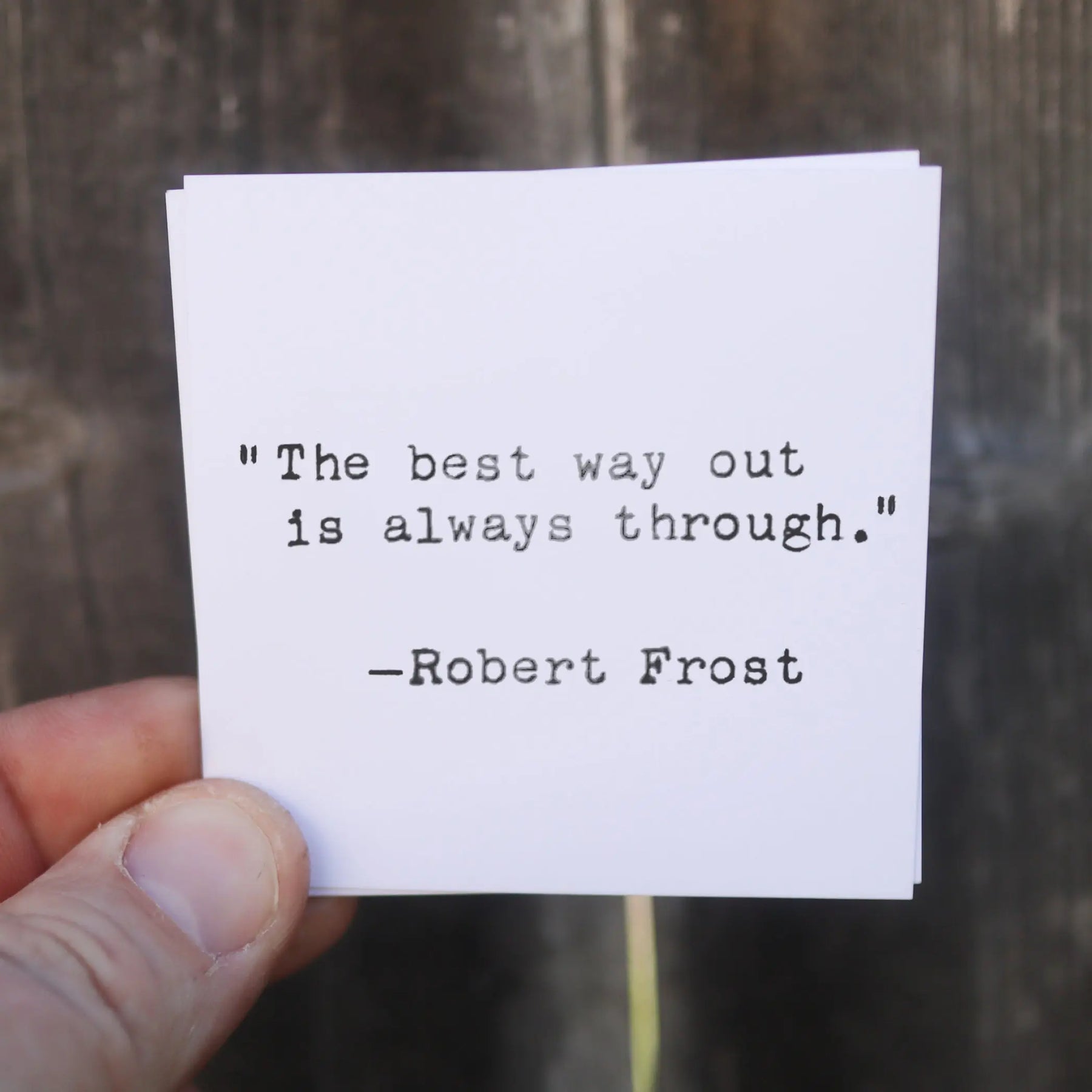 White card with black typewritten quote by Robert Frost about the best way out.