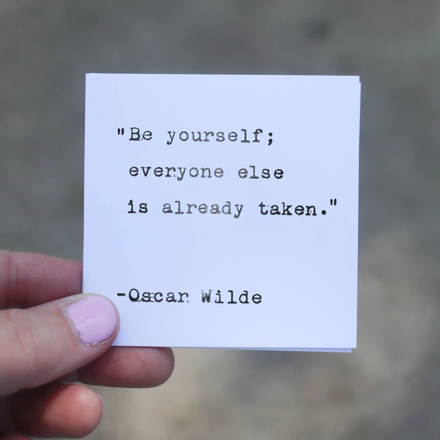 White card with typewriter quote "Be yourself; everyone else is already taken." by Oscar Wilde.