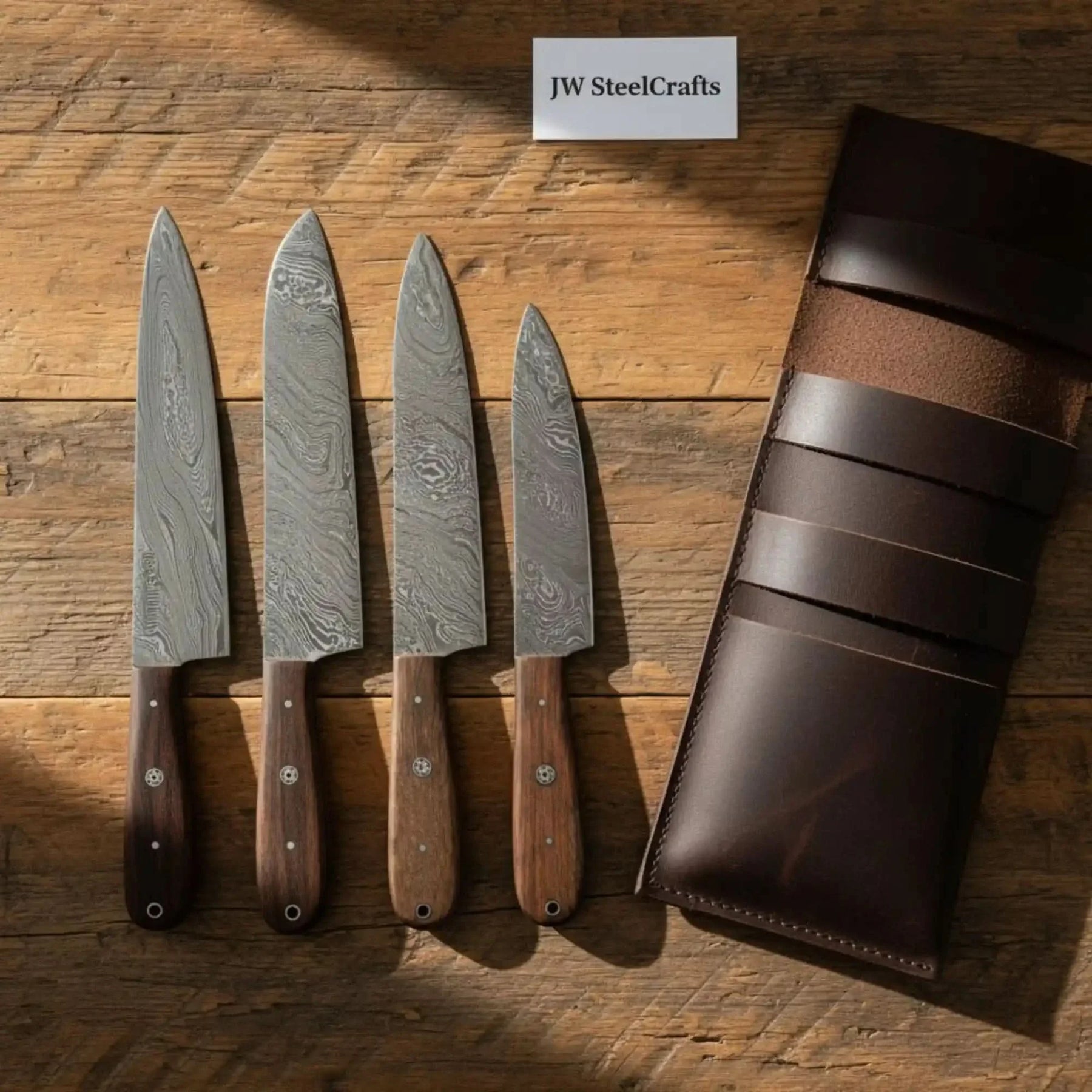 Handmade damascus steel knife with wood handle on dark surface
