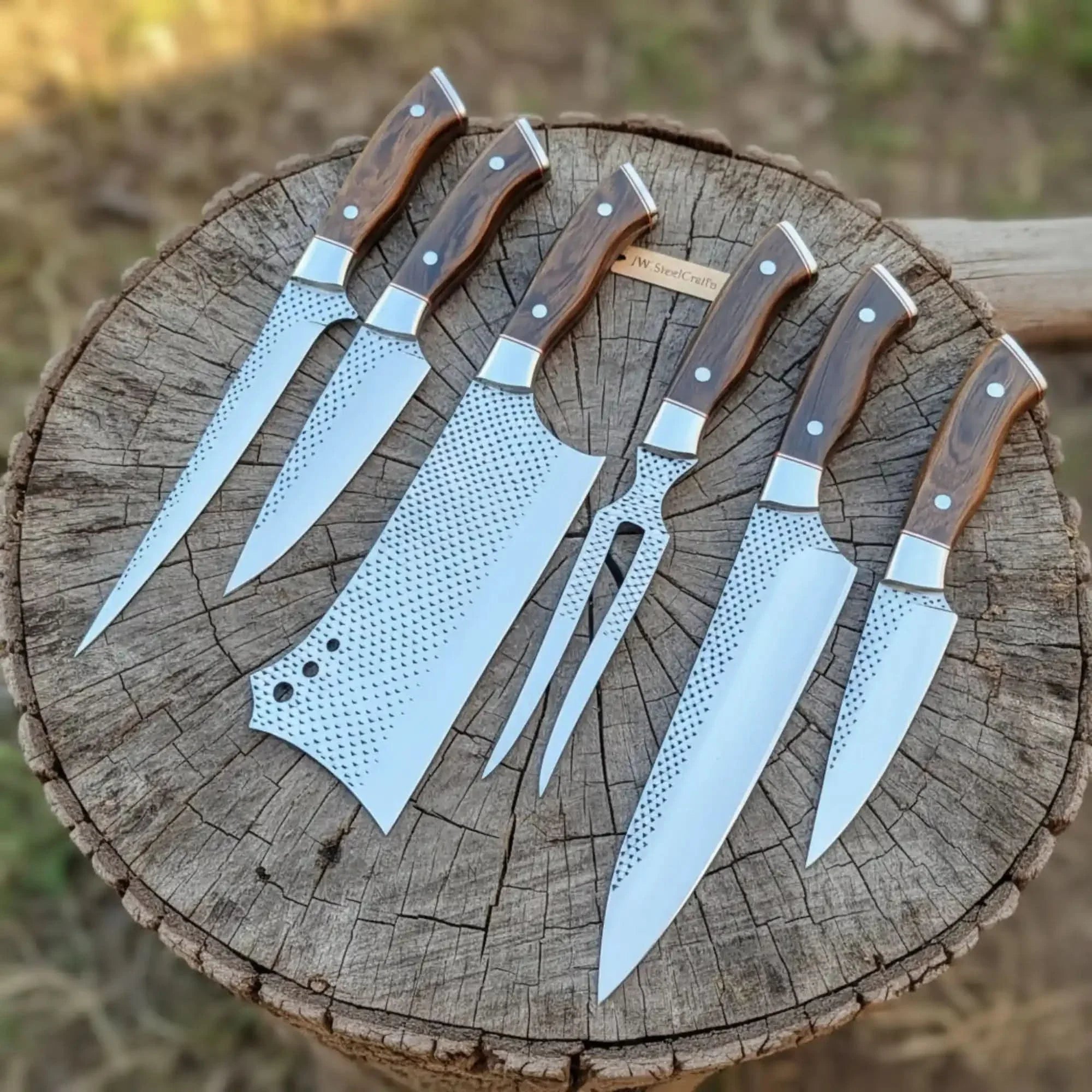 Handmade damascus steel knife with wood handle on dark surface