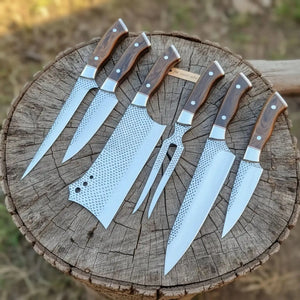 Handmade damascus steel knife with wood handle on dark surface