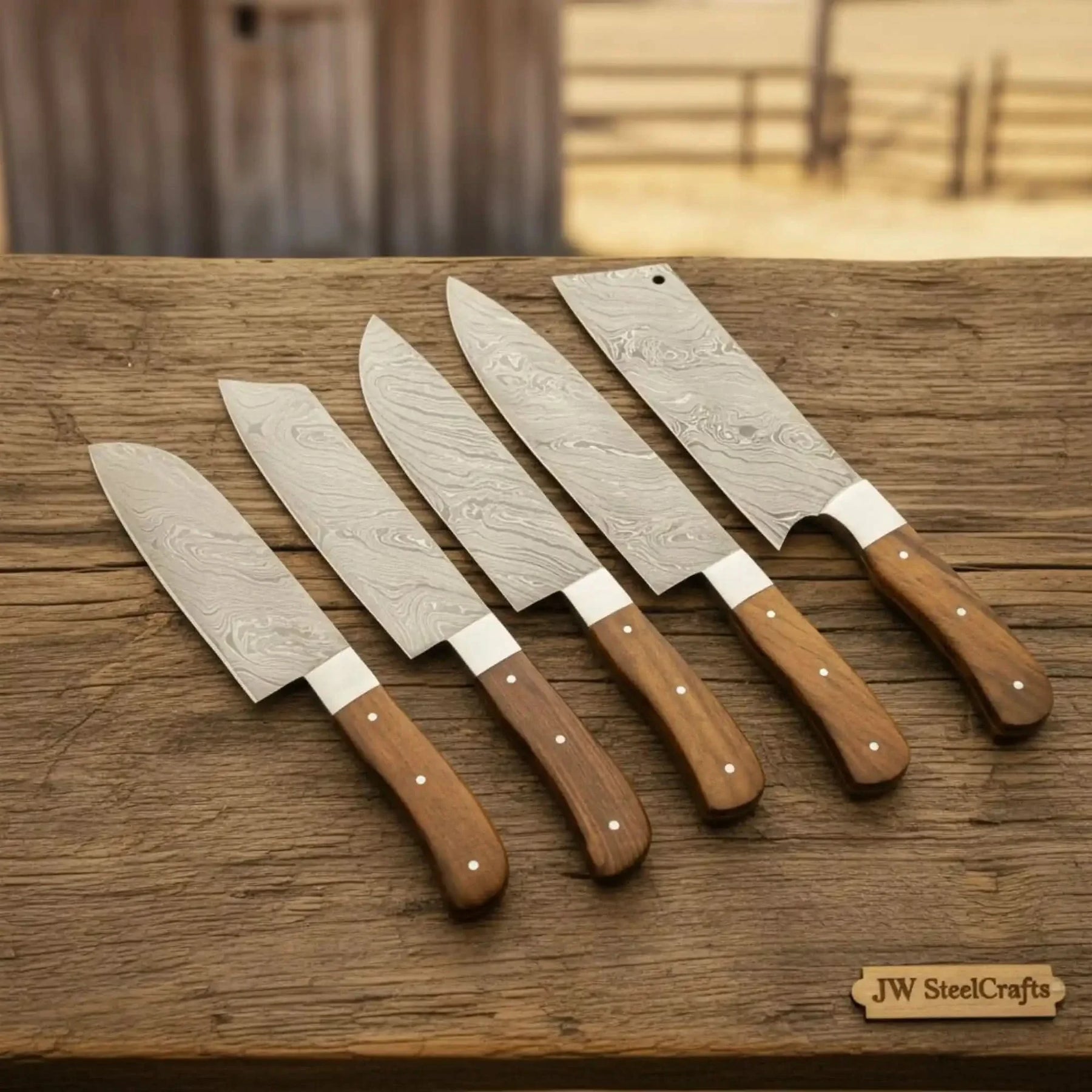 Handmade damascus steel knife with wood handle on dark surface