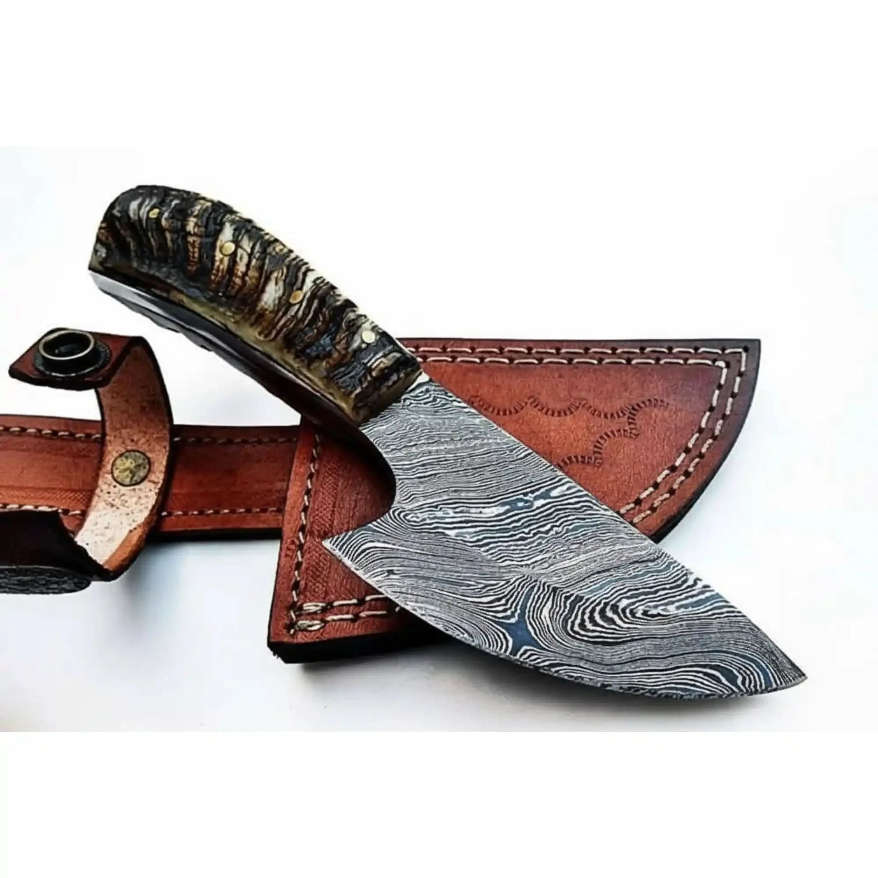 Handmade damascus steel knife with horn handle on dark surface