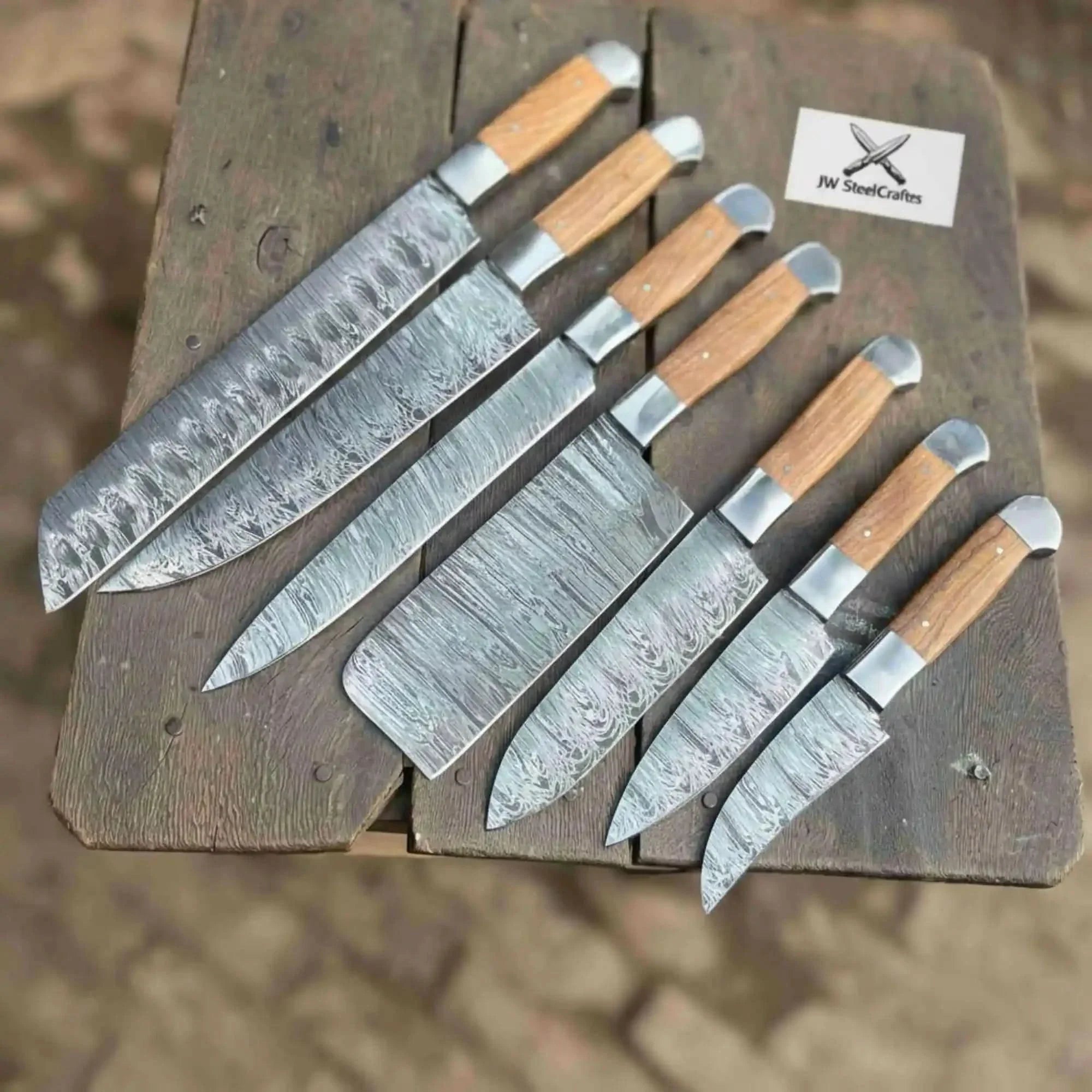 Handmade damascus steel knife with wood handle on dark surface