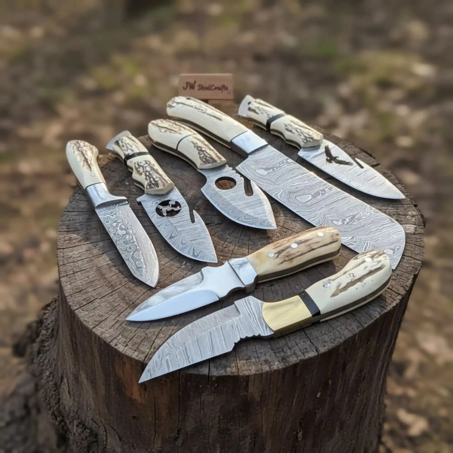Handmade damascus steel knife with premium handle on dark surface