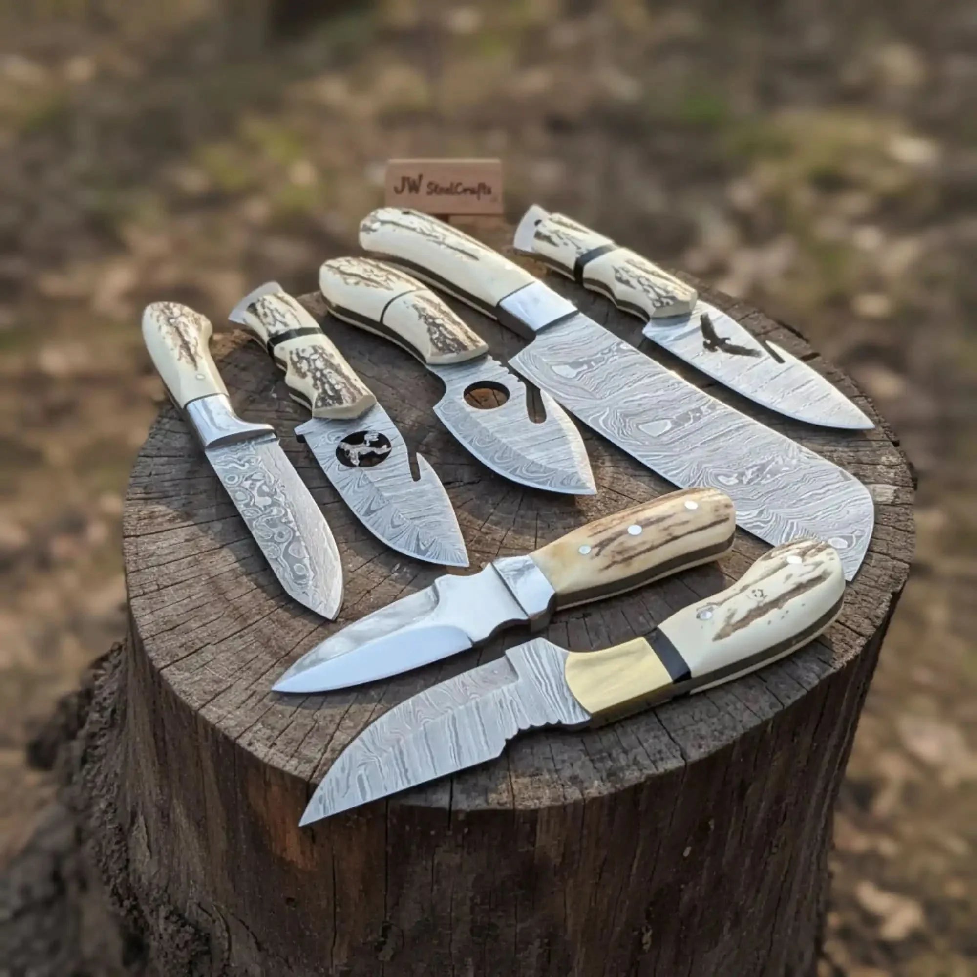 Handmade damascus steel knife with premium handle on dark surface