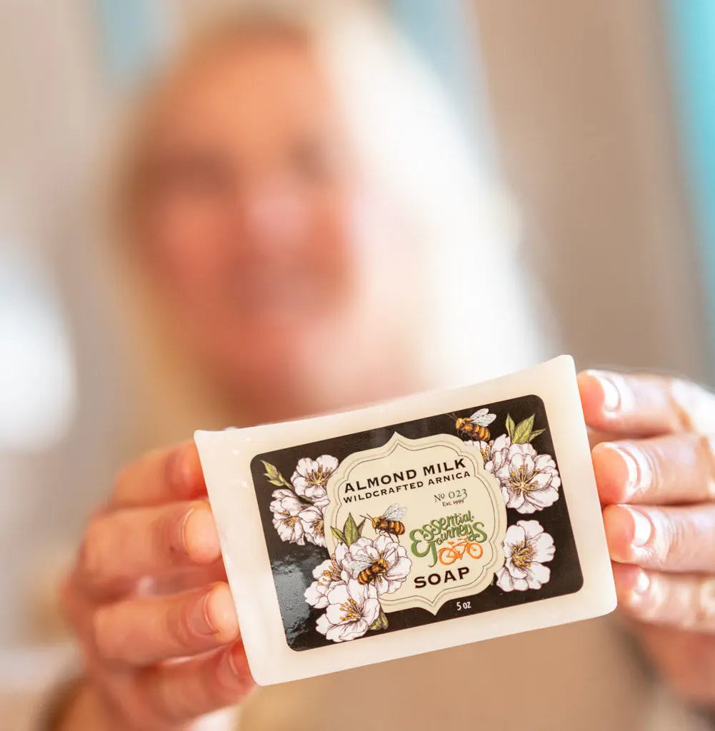 Bar of Essential Journeys Almond Milk Soap with Arnica, flowers, and bees label.