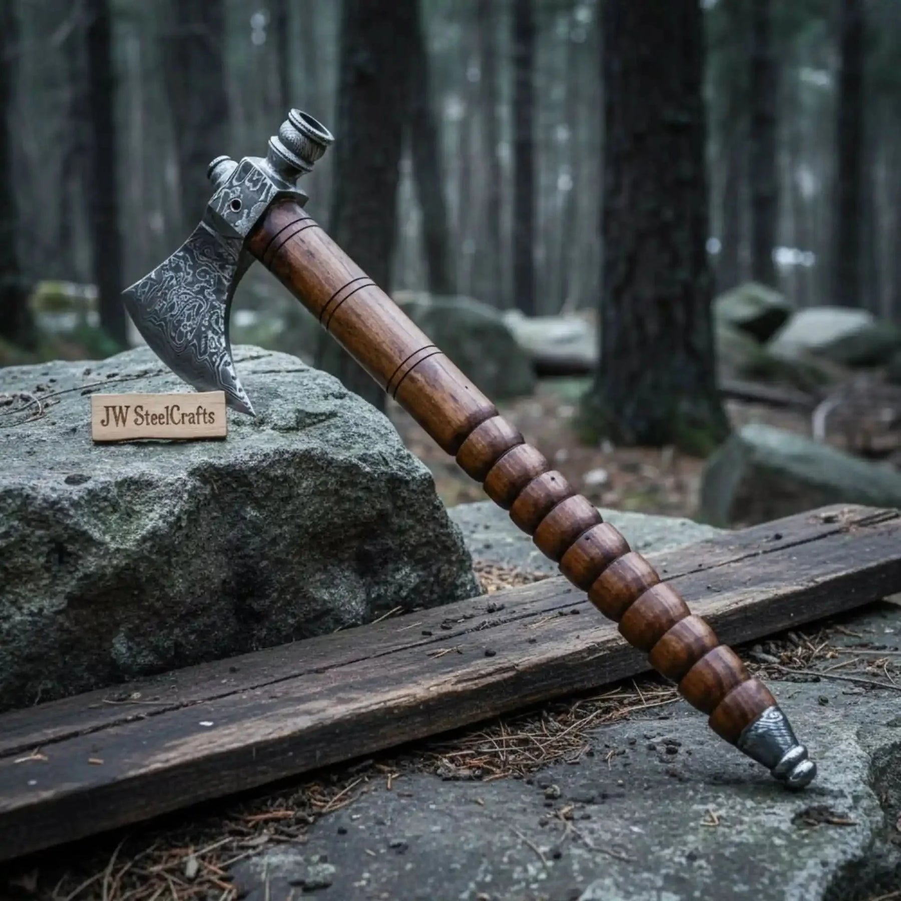 Damascus steel axe head with wood handle on rustic wood surface