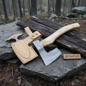 Damascus steel axe head with wood handle on rustic wood surface