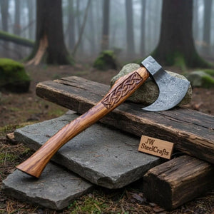Damascus steel axe head with wood handle on rustic wood surface