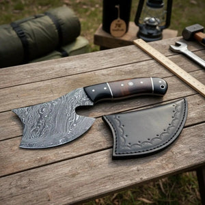 Damascus steel axe head with premium handle on rustic wood surface