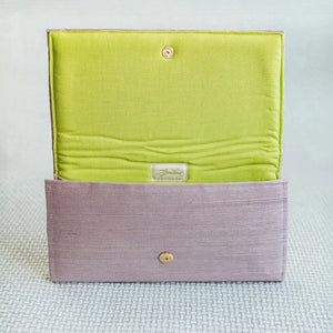 Lavender grasscloth clutch with lime green linen interior and gold snap closure.