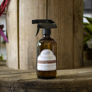 Still Magnolia all-purpose cleaner in an amber glass bottle with a cinnamon cedarwood delight label.