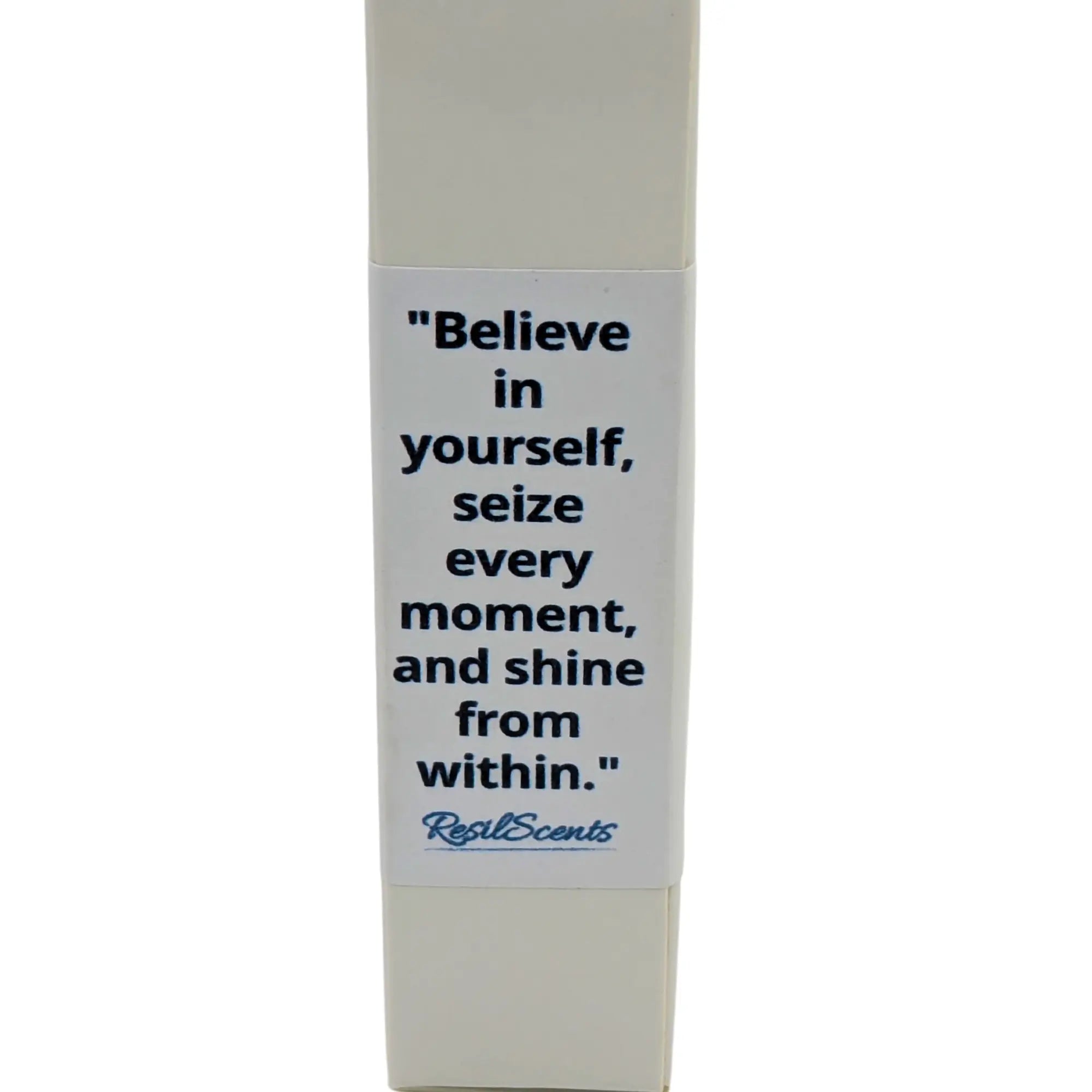 Close-up of a "Real Scents" product box with a quote: "Believe in yourself, seize every moment, and shine from within."