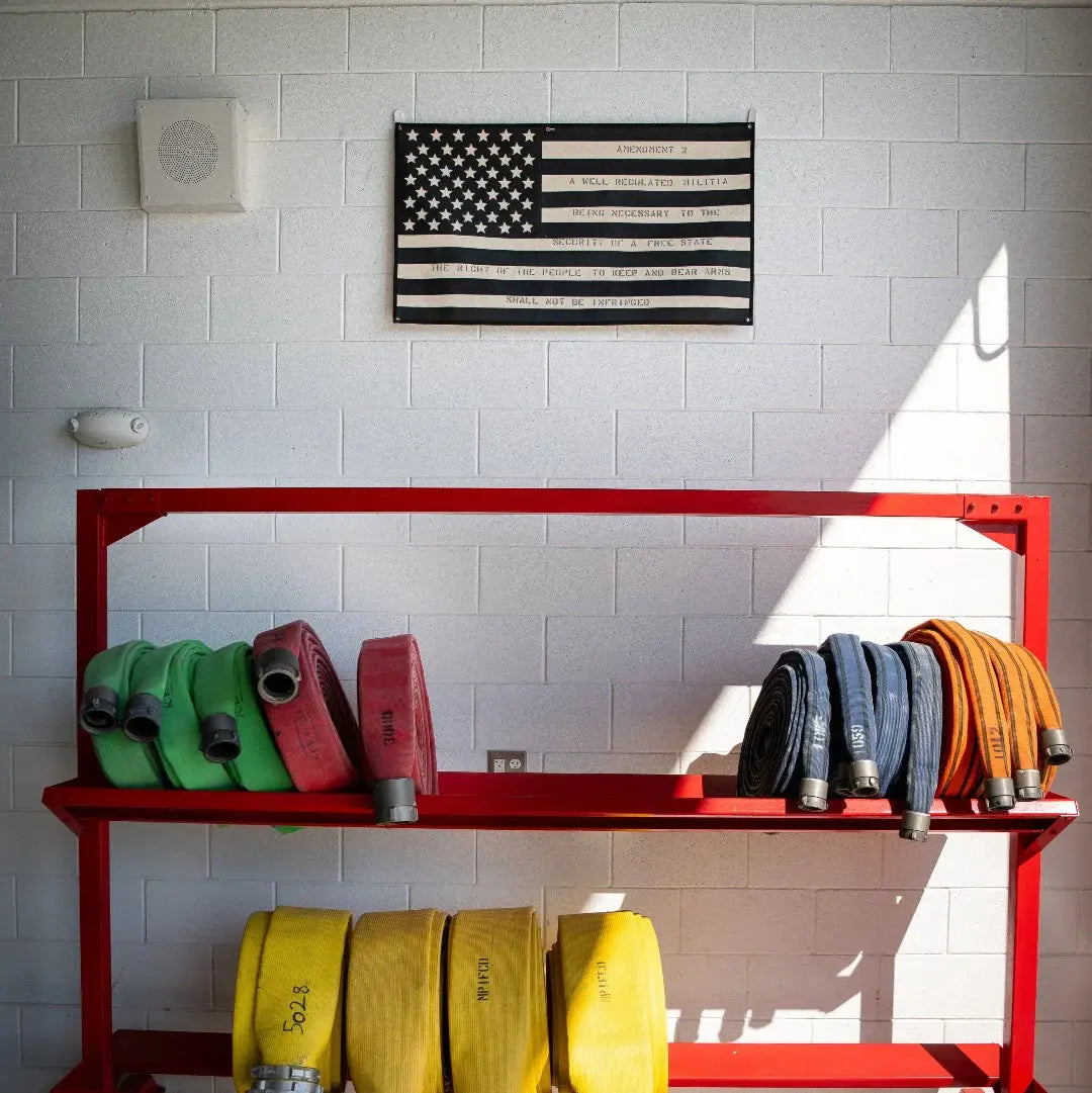 American flag made of rolled fire hoses with Second Amendment text.