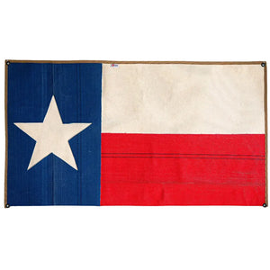 Texas flag made from repurposed red, white, and blue fire hose material.