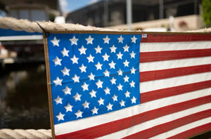 American flag made from repurposed rubber fire hose hanging on a rope.