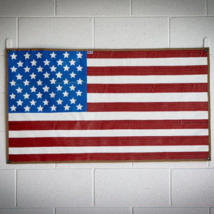American flag made from recycled waterproof fire hose with brass grommets.