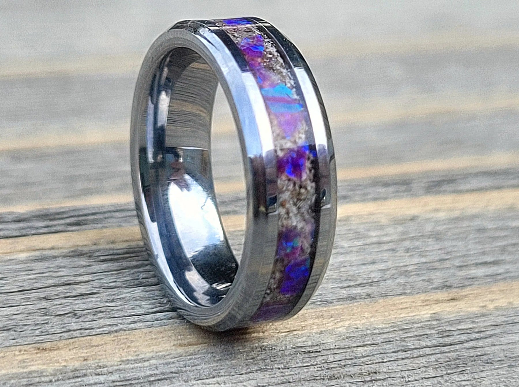 Amethyst Opal & ashes ring on wood surface, memorial jewelry remembrance, cremation ashes keepsake ring.