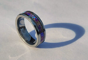 Amethyst Opal & Ashes Ring: a memorial ring with purple opal inlay and metal band, casting a shadow on a white surface.