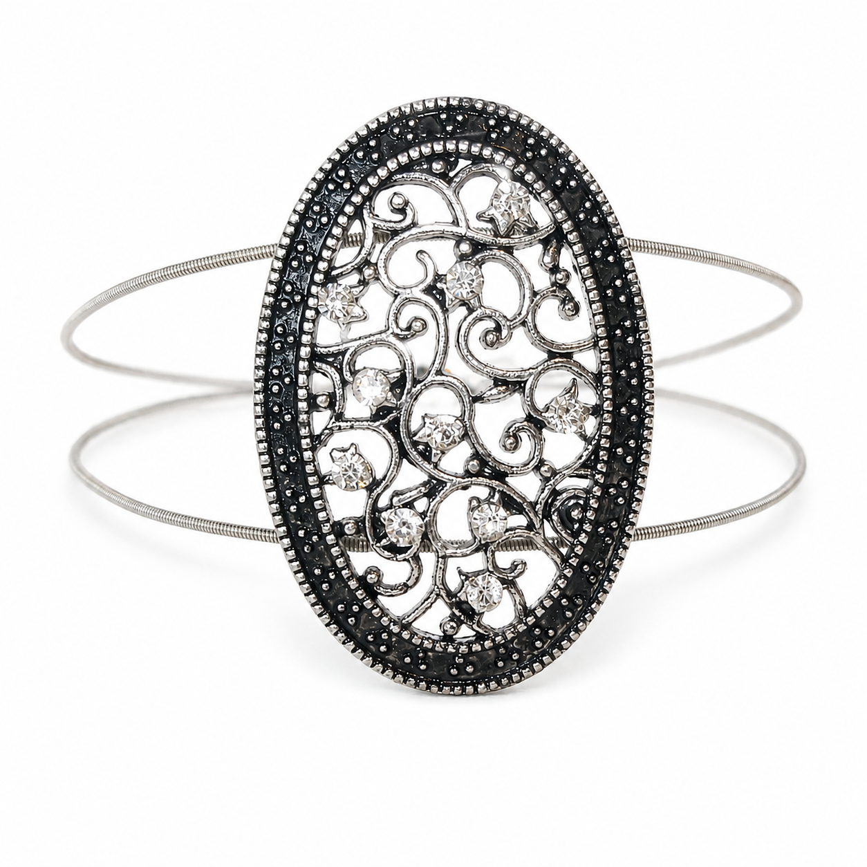 Silver filigree oval bracelet on acoustic guitar