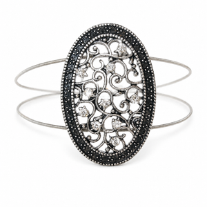 Silver filigree oval bracelet on acoustic guitar