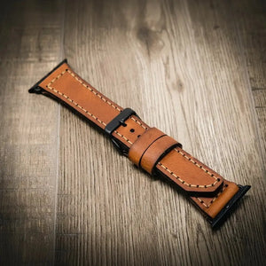 Brown full-grain leather Apple Watch band with visible stitching.