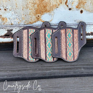Three Aztec tooled leather knife sheaths with turquoise accents.