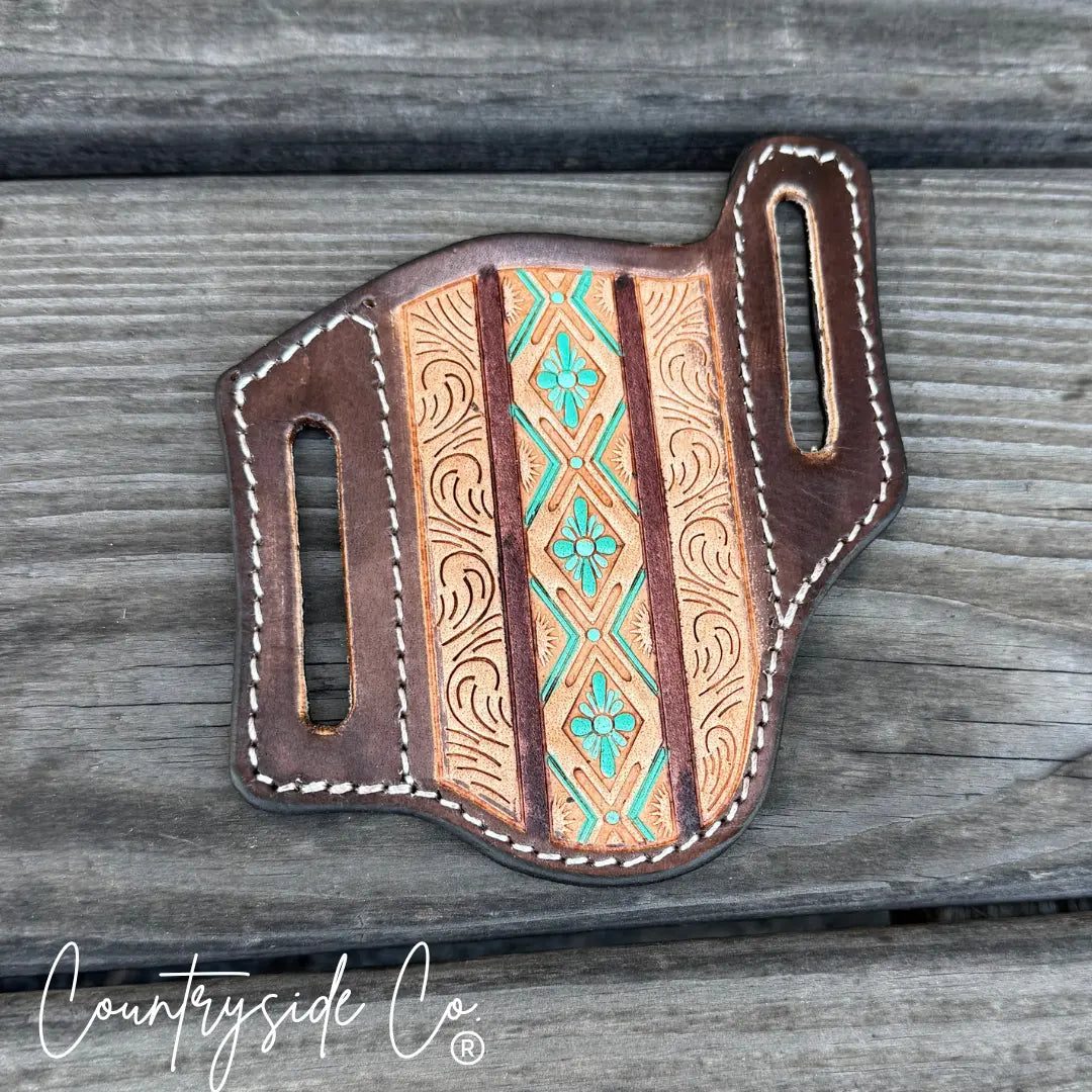 Brown Aztec tooled leather knife sheath with turquoise floral accents.