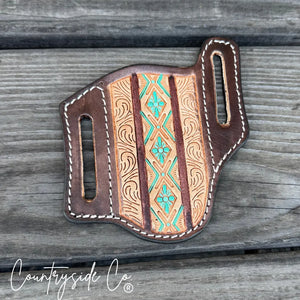 Brown Aztec tooled leather knife sheath with turquoise floral accents.