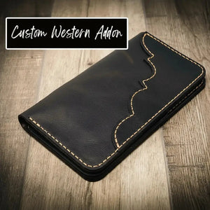 Black leather long wallet with decorative stitching and text overlay