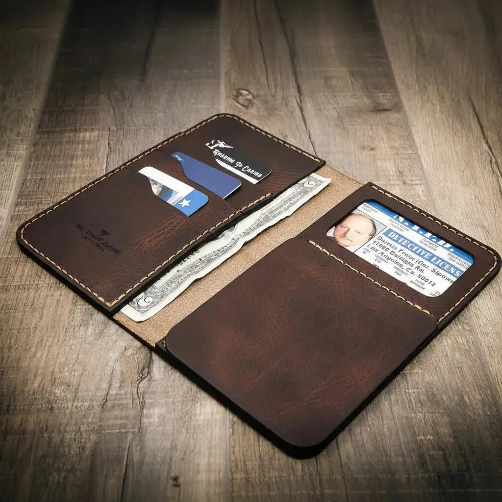 Brown leather long wallet open with ID, cash, and card slots visible.