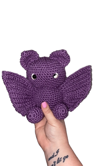 Crochet Purple Bat Plush Toy, Handmade Amigurumi by Main Street Collective. Cute handmade bat with wings, held in hand.