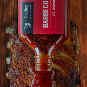Bourbon and sorghum barbecue sauce poured over cooked ribs