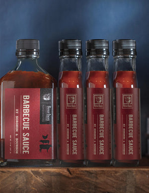 Four bottles of Bourbon Barrel Foods barbecue sauce with sorghum and bourbon