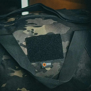 1000D camouflage barrel duffel bag with black patch and Recycled Firefighter logo