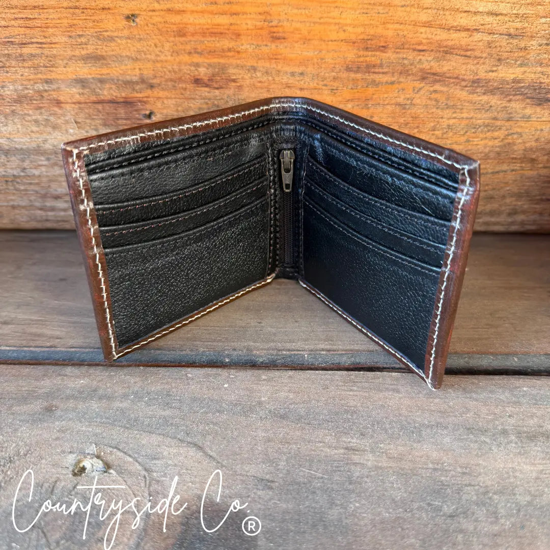 Brown leather bi-fold wallet with black interior, card slots, and zipper compartment.