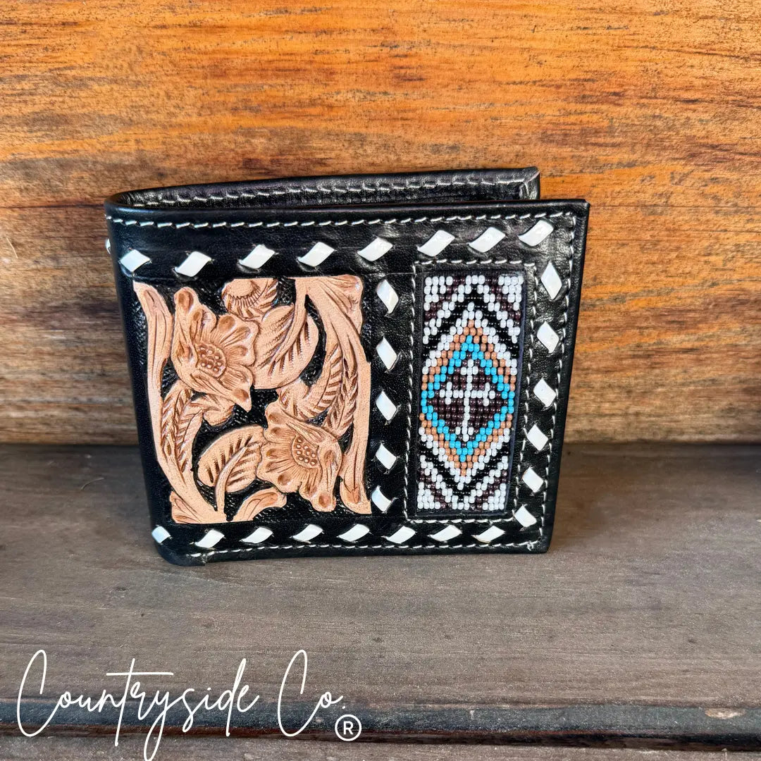 Men's black leather bi-fold wallet with beaded cross and floral tooling.